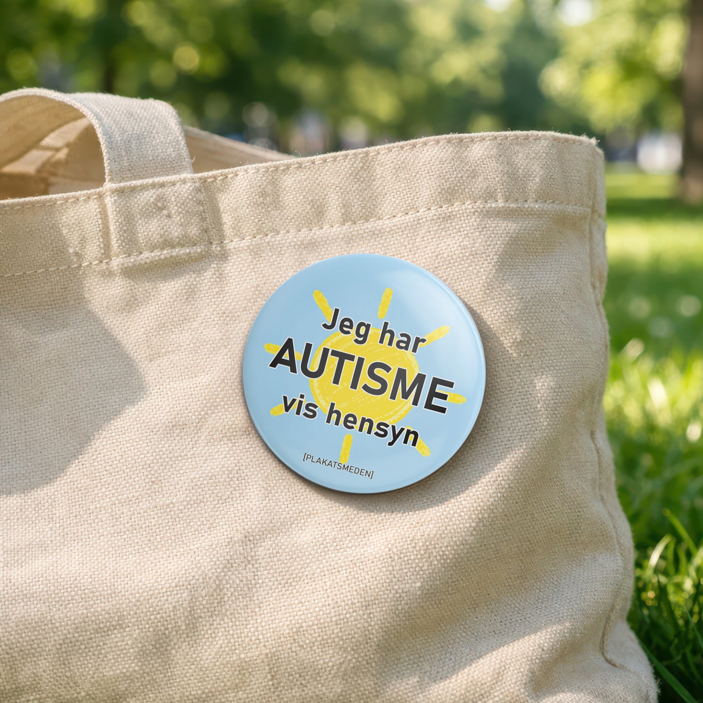 Jeg har autisme – vis hensyn" | badge med sol-motiv